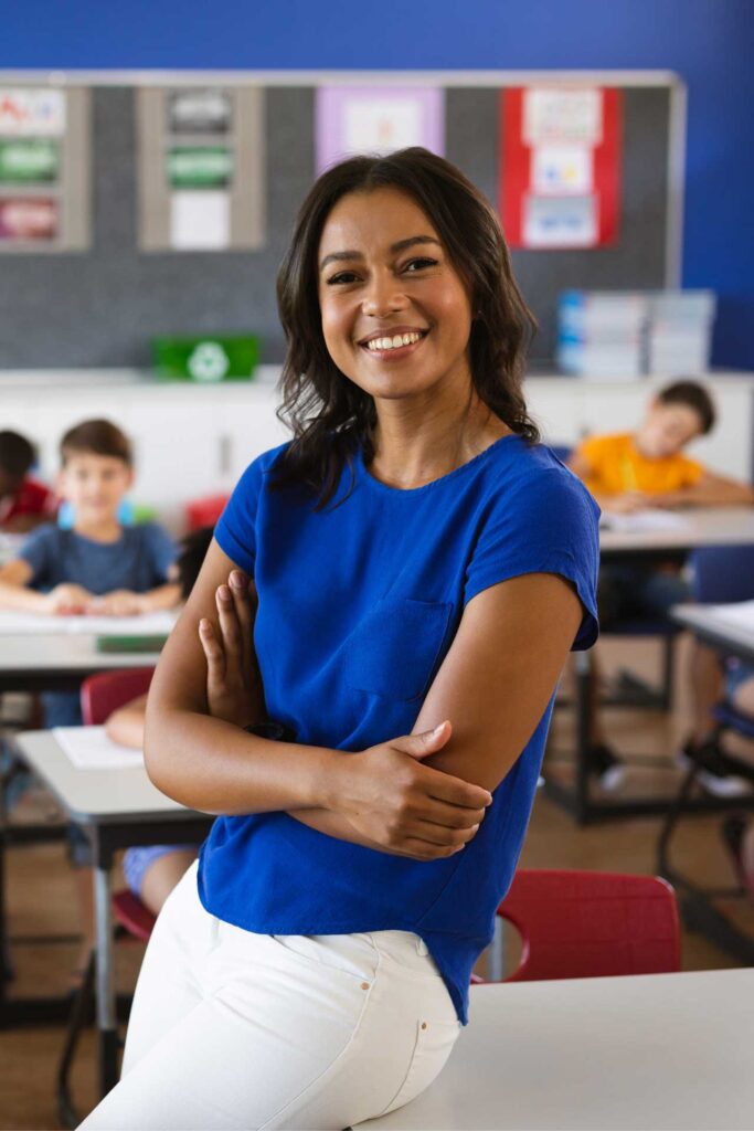 Teacher leaning on a desk